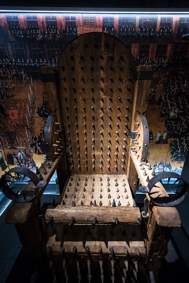 What to do in bruges: a spiked wooden chair in Bruges torture museum