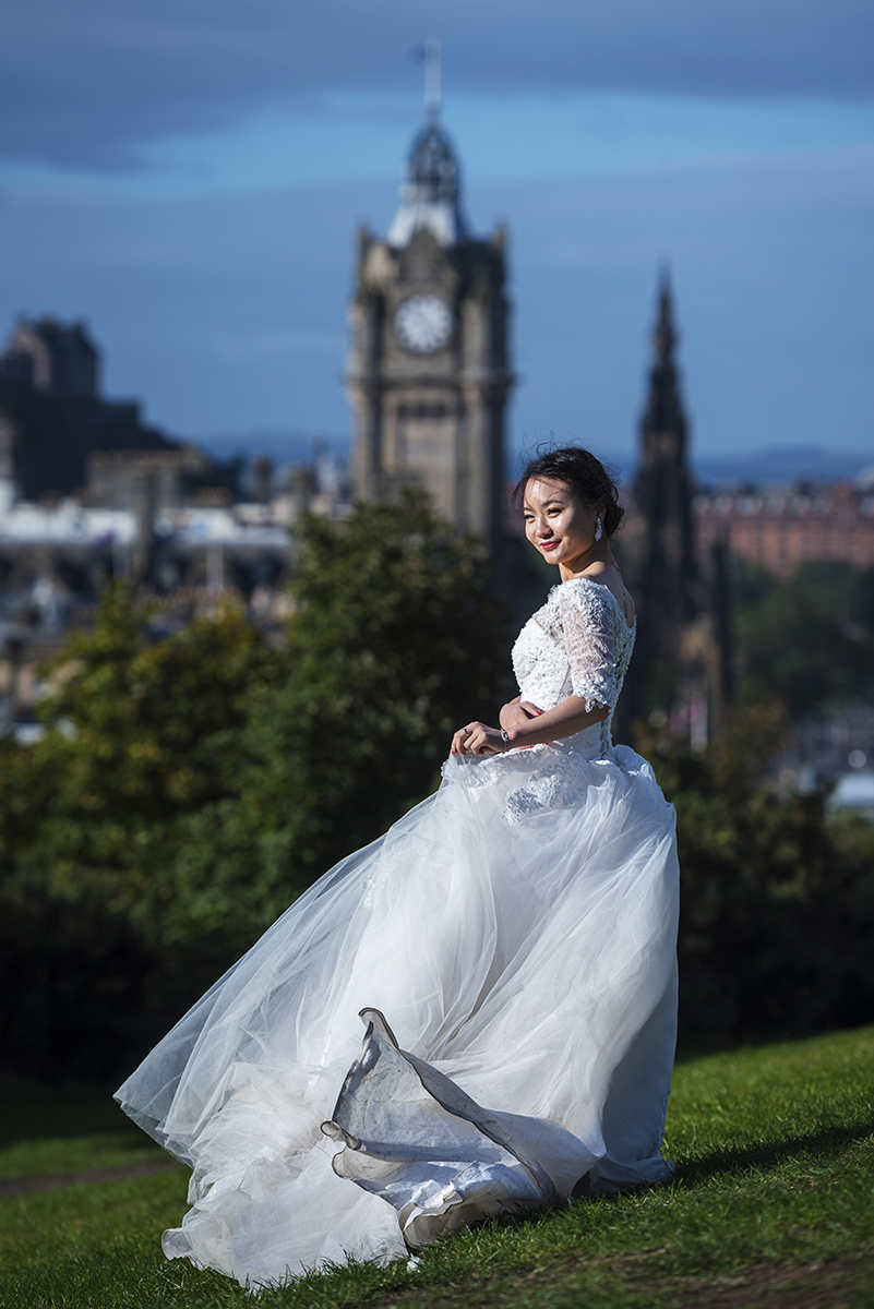 Asian girl in wedding dress on Calton Hill in Edinburgh