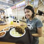 Wat te doen in Singapore - meisje eet kip in maxwell food centre Singapore